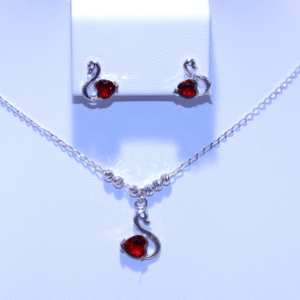 Swan-themed silver necklace with a red stone pendant