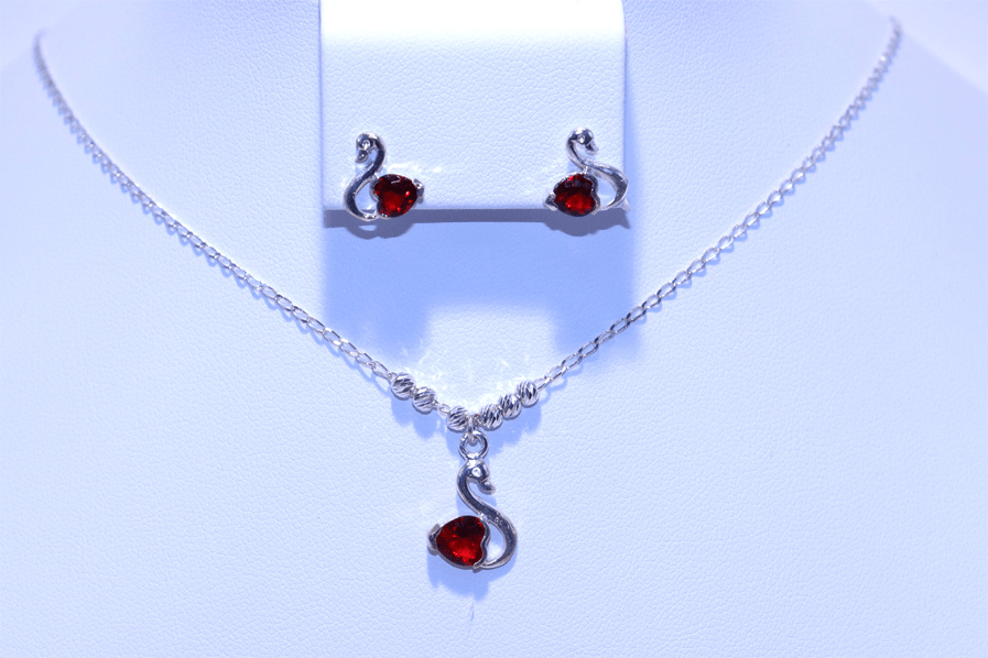 Swan-themed silver necklace with a red stone pendant